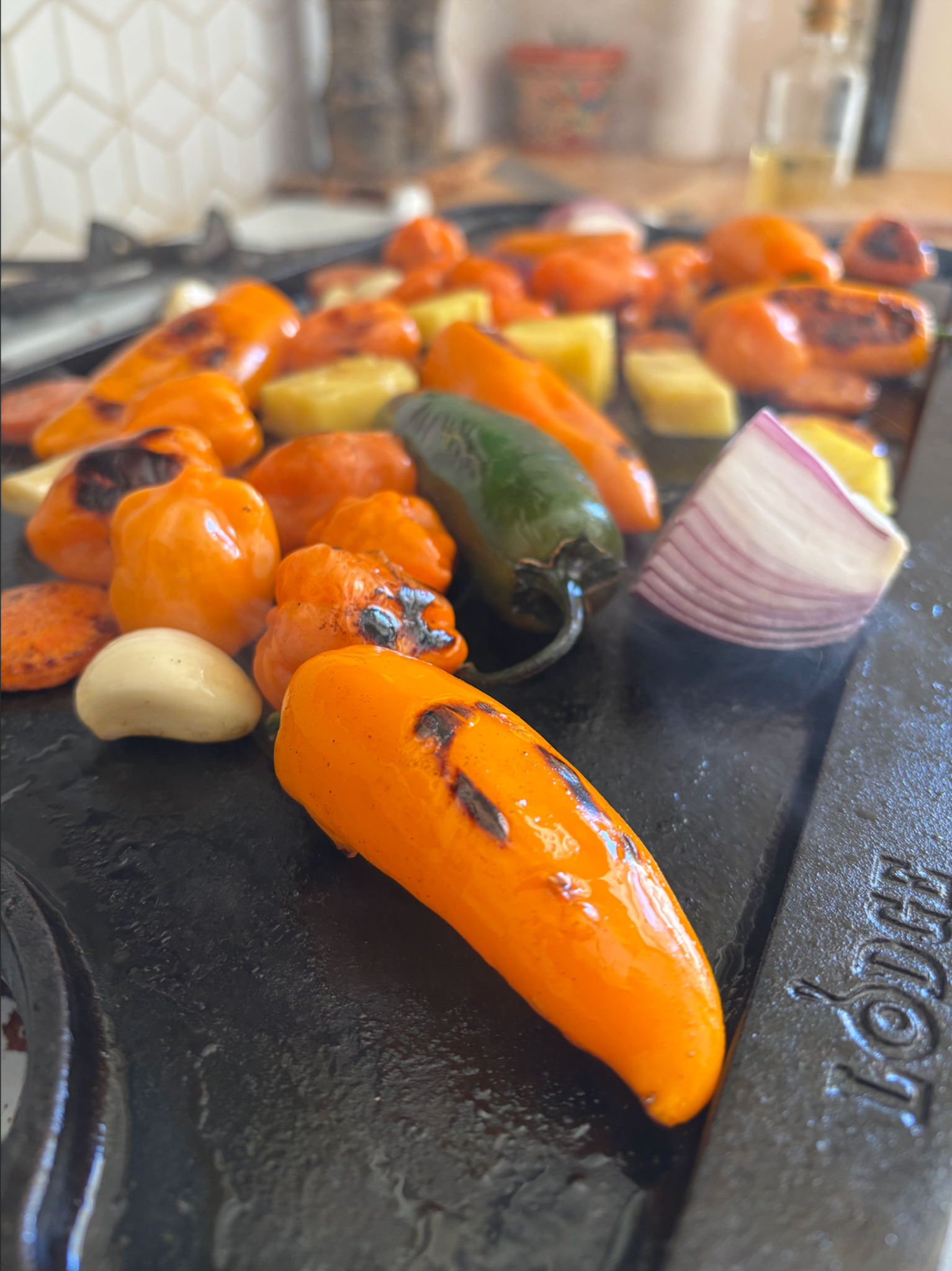 Roasted peppers, onion, garlic, and pineapple cooking for Old Guard Pepper Co hot sauce